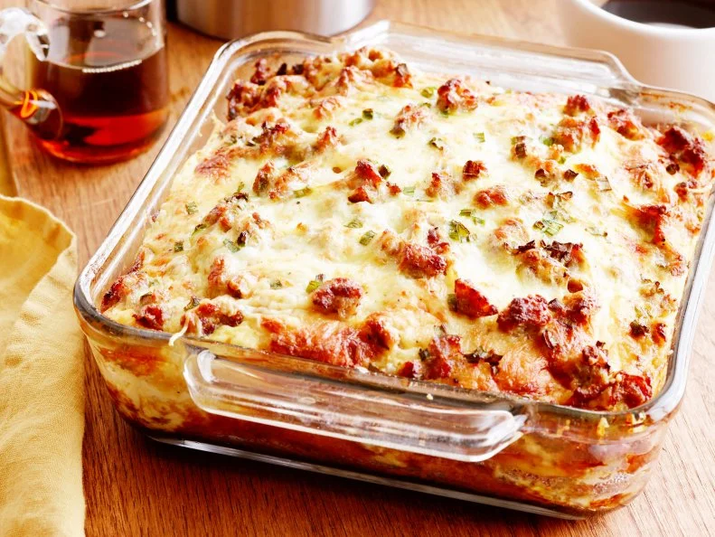 SAUSAGEANDCHEESEPANCAKE BREAKFAST CASSEROLEFood Network KitchenUnsalted Butter, AllpurposeFlour, Baking Powder, Baking Soda, Sugar, Buttermilk, Eggs,HalfandHalf,Breakfast Sausage Patties, White Cheddar Cheese, Scallions, Maple Syrup