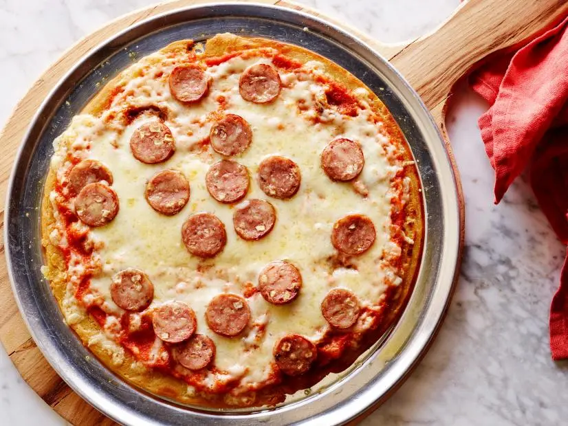 CHICKPEA CRUST PIZZAKeri GlassmanThe Food Network Blogpost Recipes/Trying New FoodsFood NetworkChickpea Flour, Garlic Powder, Salt, Olive Oil, Onion, Garlic, Carrot, Sea Salt, Pepper, CrushedTomatoes, Chicken Sausage, Provolone Cheese