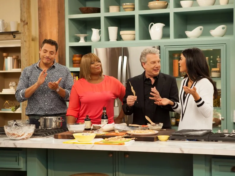 Katie Lee, far right, prepares "Pretzel Coated Chicken Skewers", for Jeff Mauro, left, Sunny Anderson, second from left, and guest Marc Summers, second from right, as seen on the Food Network's The Kitchen, Season 2.
