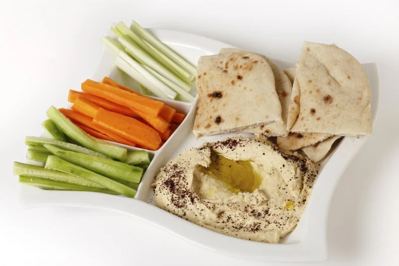 Hummus with bread and vegetable sticks