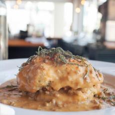 Giant stack of chedder biscuits with ancho chili gravy at Proper in Tucson, Arizona