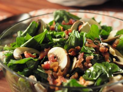 A bowl of fresh Spinach Salad with Garlic Dressing, as seen on Food Network's Trisha's Southern Kitchen, Season 4.