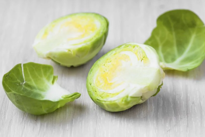 Brussels sprouts in wooden bowl on the table, tasty, healthy