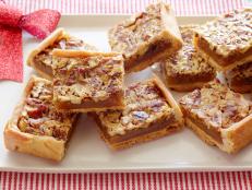 Damaris Phillips puts all the great flavors of pecan pie into an easy-to-serve bar. She gives the filling her own spin with a touch of bourbon and orange zest.