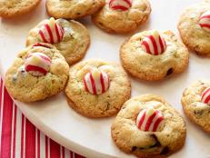 Nancy Fuller's Christmas cookies are filled with macadamia nuts and almonds and finished with a red-and-white striped chocolate kiss candy.