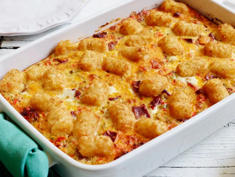 CORNED BEEF HASH BROWN CASSEROLEFood Network KitchenFood NetworkVegetable Oil, Potatoes Tots, Yellow Onion, Red Bell Pepper, Green Bell Pepper, Kosher Salt,Black Pepper, Sliced Deli Corned Beef, Eggs, Milk, Dry Mustard, Hot Sauce, Cheddar Cheese