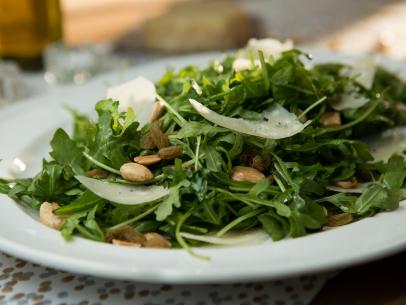 Host Tiffani Thiessen's starter dish, Arugula with Almonds, Shaved Parmesan and Truffle Oil Dressing, as seen on Cooking Channel's Dinner At Tiffani's, Season 1.