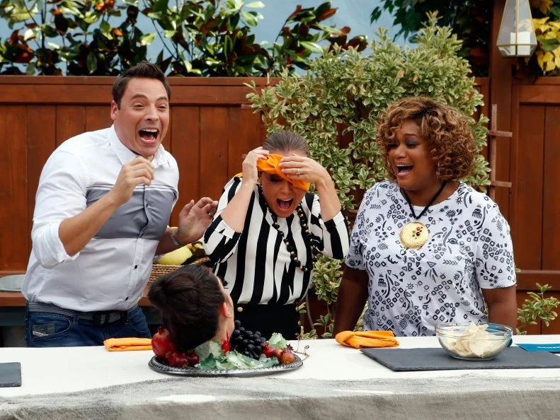 Host Jeff Mauro leads fellow hosts Sunny Anderson and Marcela Valladolid through the Terrifying Touch Test with host Katie Lee as seen on Food Network's The Kitchen, Season 7.