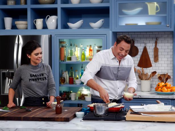 Host Jeff Mauro prepares his Macsagna for fellow host Katie Lee as seen on Food Network's The Kitchen, Season 7.
