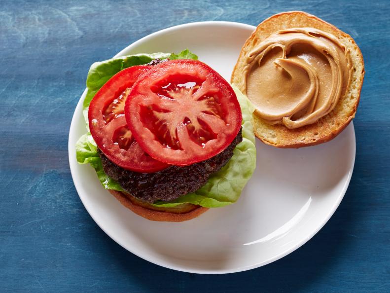 Hamburgers topped with peanut butter.