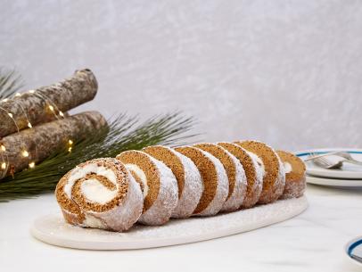 How To Fill and Roll a Jelly Roll Using a Towel: Rolling, Forming, and Unrolling a Gingerbread Roulade Cake with a Towel then Filling with Cream Cheese Frosting then Rolling To Create A Jelly Roll for Holiday Baking Championship Season 2 Eatertainment, as seen on Food Network.