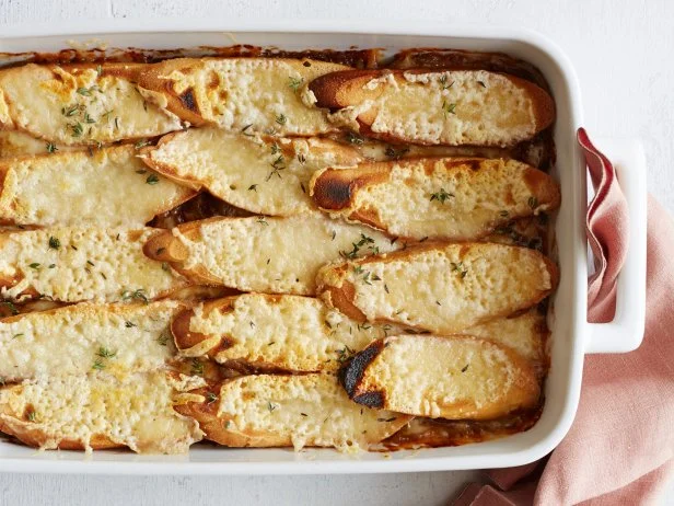 FNK FRENCH ONION SOUP CASSEROLE Food Network Kitchen Food Network Unsalted Butter, Olive Oil, Yellow Onions, Celery, Bay Leaves, Thyme, Allpurpose Flour, Beef Broth, White Wine, Baguette, Gruyere Cheese