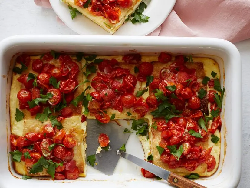 FNK GRILLED CHEESEANDTOMATO CASSEROLE Food Network Kitchen Food Network Unsalted Butter, White Bread, Cheddar Cheese, Swiss Cheese, Parmesan, Cherry or Grape Tomatoes, HalfandHalf, Mayonnaise, Eggs, Parsley