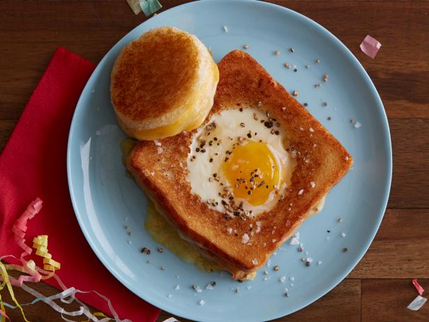 FNK HANGOVER TOADINTHEHOLE GRILLED CHEESE SANDWICH Food Network Kitchen Food Network White Bread, Mayonnaise, American Cheese, Pepper Jack or Monterey Jack Cheese with Peppers, Egg, Unsalted Butter