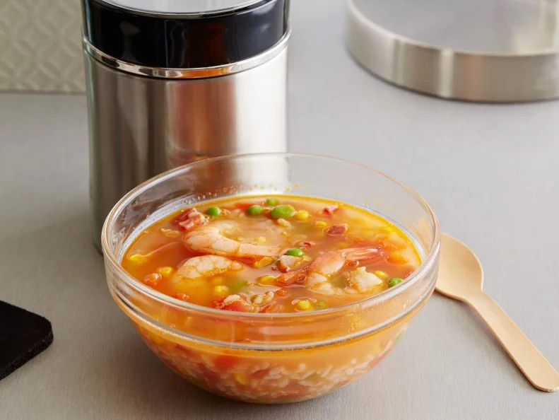 FNK JUSTADDWATER SHRIMP PAELLA SOUP Food Network Kitchen Food Network White Rice, Corn, Peas, Shrimp, Chorizo, Tomato Paste, Chicken Base, Paprika