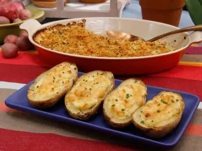 Katie Lee's Cheesy Twice Baked Potatoes, front, and Geoffrey Zakarian's Yukon Gold Potato Gratin are seen on the set of Food Network's The Kitchen, Season 8.