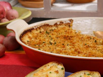 Katie Lee's Cheesy Twice Baked Potatoes, front, and Geoffrey Zakarian's Yukon Gold Potato Gratin are seen on the set of Food Network's The Kitchen, Season 8.
