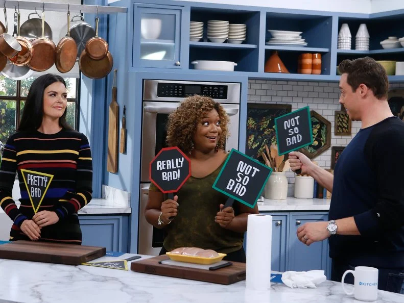 Co-hosts Sunny Anderson, left, Katie Lee and Jeff Mauro participate in a How Bad Is It segment as seen on Food Network's The Kitchen, Season 7.