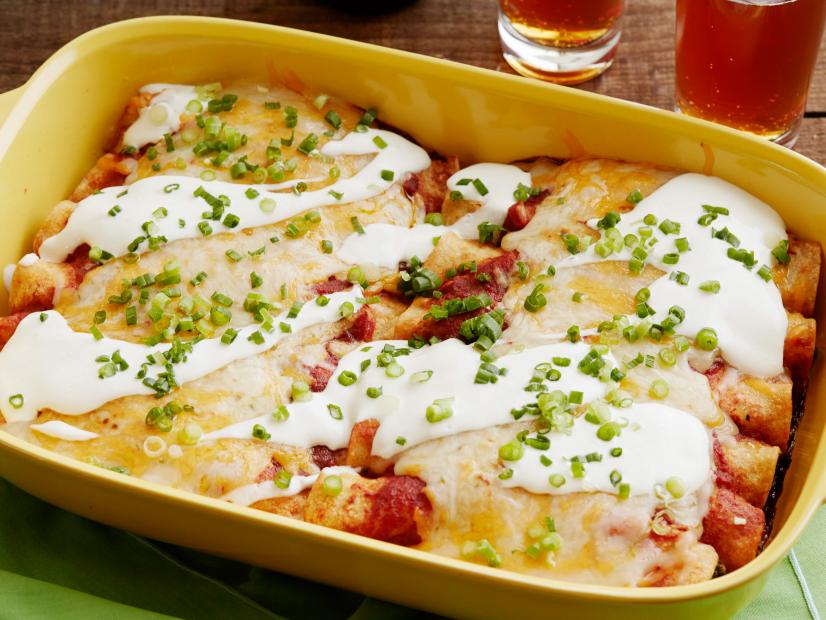 FNK VEGETARIAN ENCHILADAS (evergreen) Food Network Kitchen Food Network Onion, Garlic, Ancho Chile Powder, Cumin, Cayenne Pepper, Tomato Puree, Spinach, Pinto Beans, Cheddar, Pepper Jack, Sour Cream, Scallions, Corn or Flour Tortillas, Lime