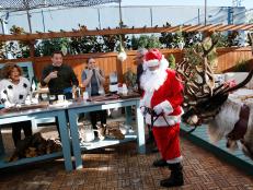 From left, hosts Sunny Anderson, Jeff Mauro, Marcela Valladolid and Geoffrey Zakarian get a visit from Santa and a reindeer as seen on Food Network's The Kitchen, Season 8.