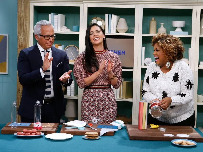From left, hosts Geoffrey Zakarian, Katie Lee and Sunny Anderson demonstrate various craft ideas for creating cookie packaging as seen on Food Network's The Kitchen, Season 8.