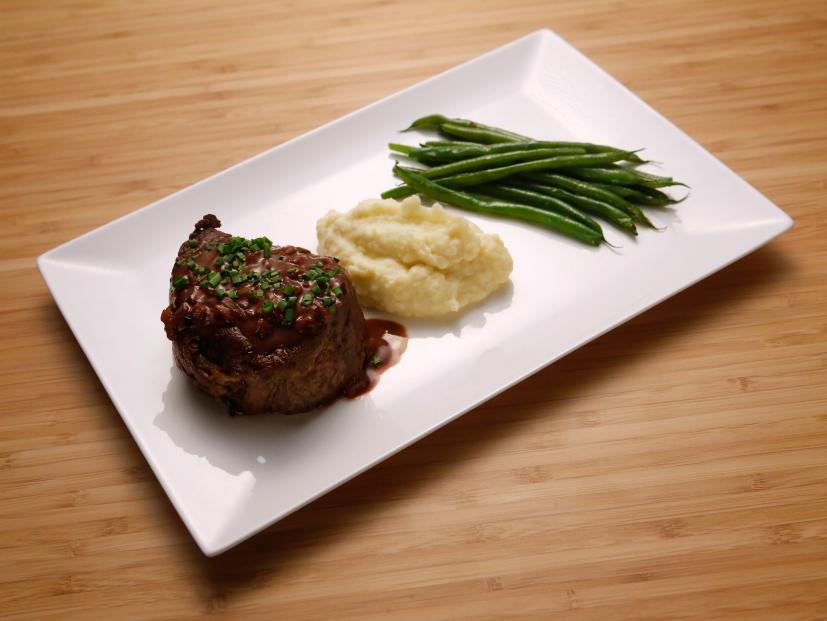 Host Anne Burrell's Mushroom and Blue Cheese Stuffed Filet Mignon with Celery Root and Potato Puree and Haricot Vert dish is seen on the set of Food Network's Worst Cooks in America, Season 8.