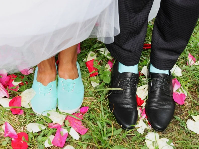 Legs bridal, groom wearing shoes, bride's moccasins