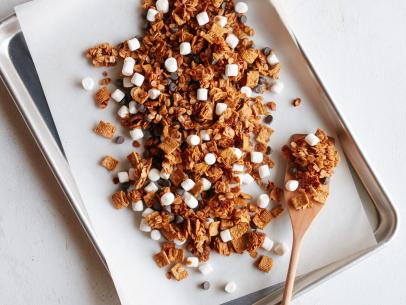 FNK S’MORES GRANOLA Food Network Kitchen Food Network Unsalted Butter, Light Brown Sugar, Honey, Vanilla Extract, Rolled Oats, Graham Flavored Cereal, Mini Marshmallows, Semisweet Chocolate Chips