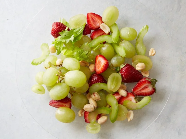 Food Network Kitchenâ  s Grape Strawberry Celery Honey and Roasted Peanuts Fruit Salad as seen on Food Network.