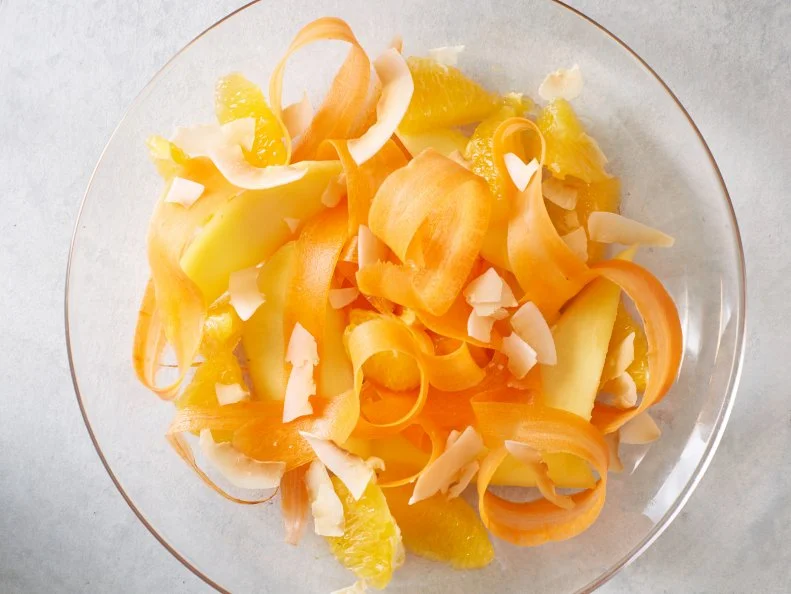 Food Network Kitchenâ  s Mango, Orange, Carrots, and Toasted Coconut Fruit Salad as seen on Food Network.