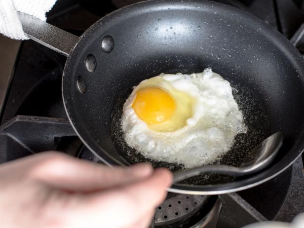 Spoon oil over the yolk
