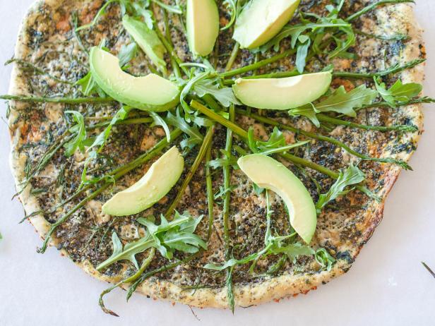 Jackie Alpers' Spring Entertaining made easy with homemade Pizza.  dried herbs mixed into the crust, blue cheese, grated parmesan, blanched asparagus, arugula, and avocado. Recipe and food photography by Jackie Alpers for the Food Network.