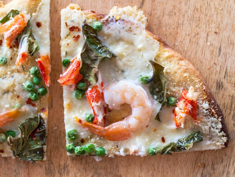 Jackie Alpers' Spring entertaining made easy with homemade pizzza. Garlic butter herb crust, King crab, shrimp fresh peas, fresh basil, Franklinâ  s Telemere cheese. Recipe and food photography by Jackie Alpers for the Food Network.