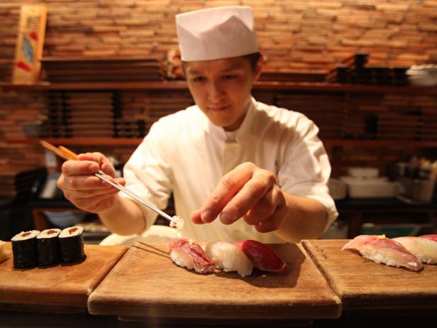 The itamea adds finishing touches to a piece of nigiri sushi at Blue Ribbon Sushi Izakaya, NYC.