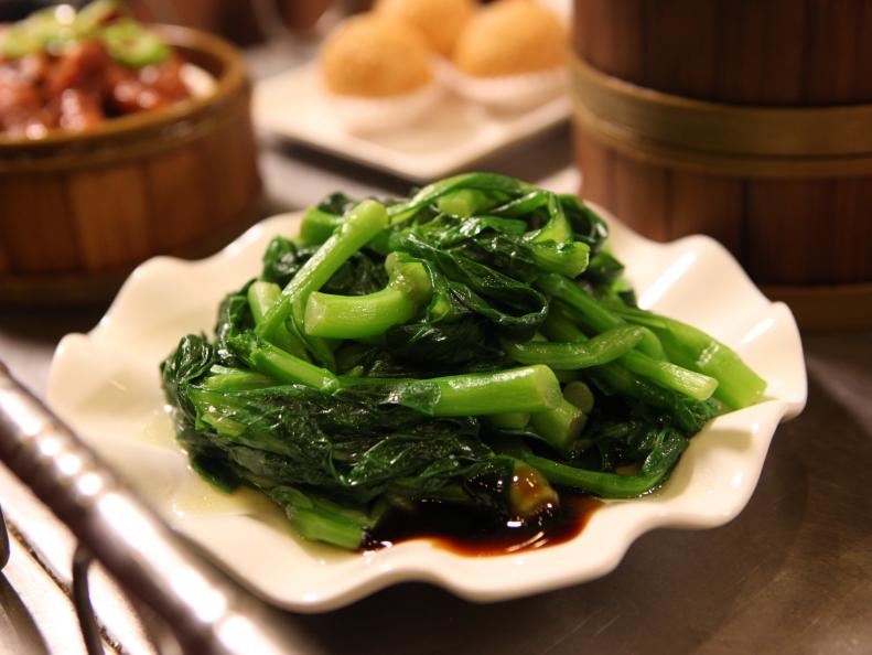 A plate of Gai Lan, Chinese broccoli coated with soy sauce at Jing Fong.