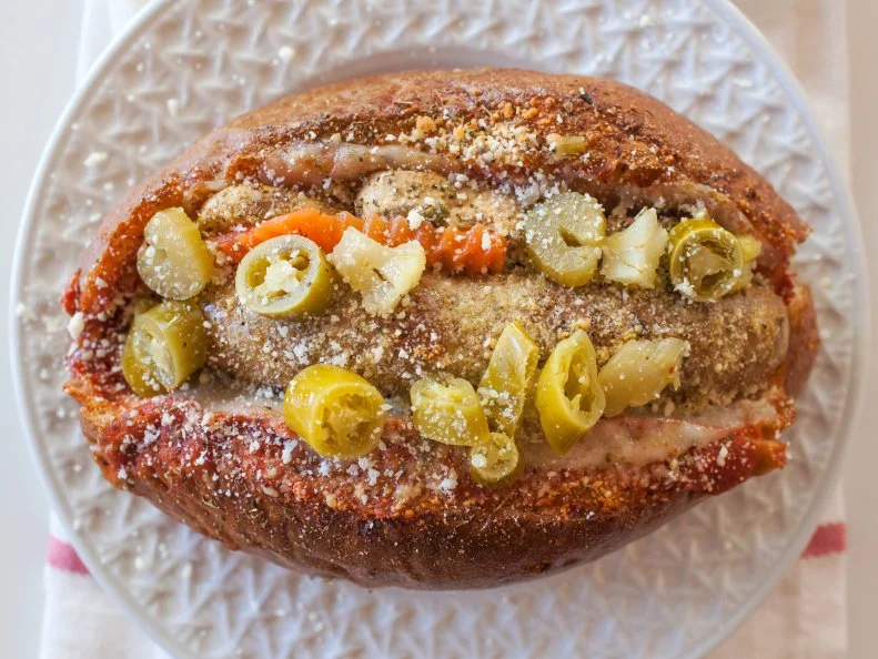 The Italian Stallion hot dog is a top split Italian roll, marinara sauce, Provolone cheese, Parmesan, and  spicy giardiniera. Recipe and food photography by Jackie Alpers for FoodNetwork.com