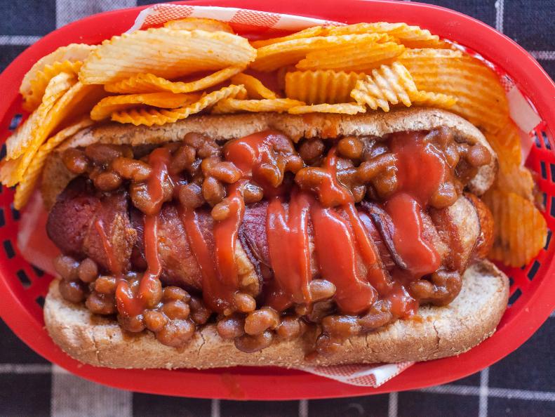 My Mom's famous baked beans top a bacon wrapped hot dog. Recipe and food photography by Jackie Alpers for Food Network.com