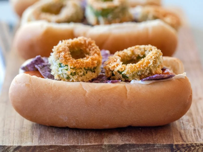 Veggie Dog topped with cream cheese, fried jalapenos and crushed tortilla chips. Recipe and photo by Jackie Alpers for the FoodNetwork.com