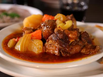 Bowl of oxtail stew with a side of bread from Pyrenees CafÃ© in Bakersfield, CA as seen on Food Network's Diners, Drive-Ins and Dives episode DV2209.