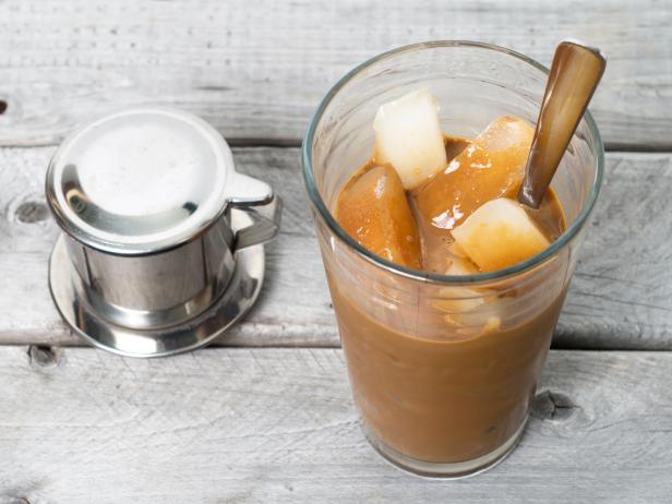 Vietnamese ice coffee with condensed milk, cafe sua da on a wooden background