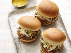 Barbecue is serious business in a lot of Southern families, and Trisha Yearwood's is no exception. Throughout her childhood in Georgia, her father's pulled pork-an all-day project-was a must on the Fourth of July and at other summer get-togethers. "He would slow-cook it on a covered grill and have to keep going back to baste it all day long." Now that Trisha throws the family's annual Fourth of July party, she has figured out a way to adapt her dad's recipe for the slow cooker, so she won't have to keep disappearing to tend to the meat.