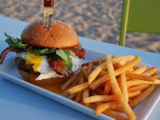 Bite into over-the-top burgers while soaking up a stunning ocean vista at this casual eatery. Follow Curtis Stone&rsquo;s lead and indulge in a grass-fed beef patty piled high with rich toppings like melty Tillamook cheddar, a runny fried egg, apple-wood-smoked bacon and tangy aioli for an added kick.