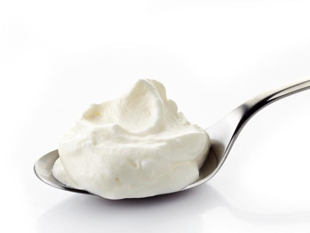 whipped cream in a spoon on white background