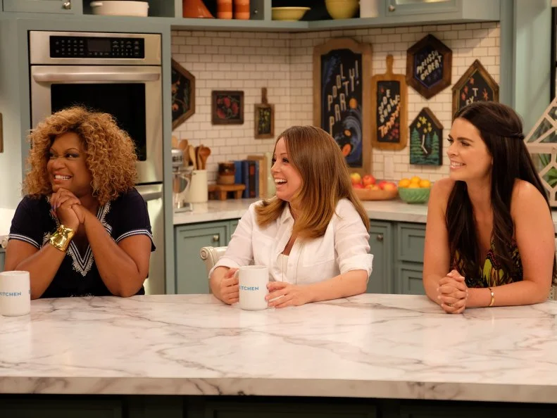 Hosts, Katie Lee, Marcela Valladolid, and Sunny Anderson as seen on Food Networkâ  s The Kitchen, Season 6.,Hosts, Katie Lee, Marcela Valladolid, and Sunny Anderson as seen on Food Network’s The Kitchen, Season 6.