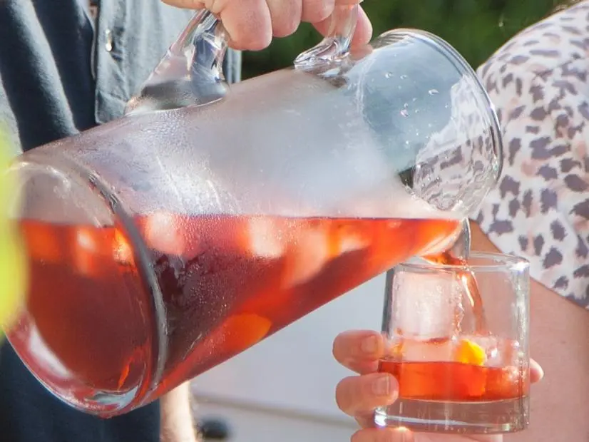Husband Tom Vitale pours host Valerie Bertinelli a glass of his special Negroni, as seen on Valerieâ  s Home Cooking.
