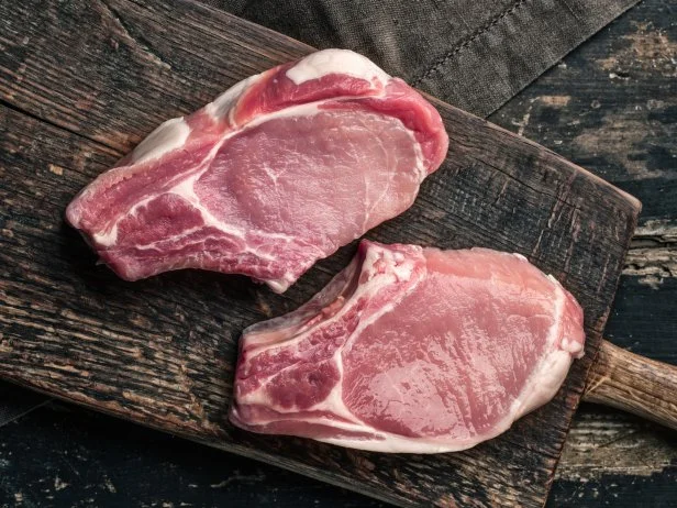 fresh raw meat on old wooden cutting board