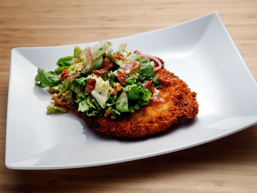 Host Anne Burrell's Chicken Milanese with Escarole Salad dish is displayed on the set of Food Network's Worst Cooks in America, Season 8.