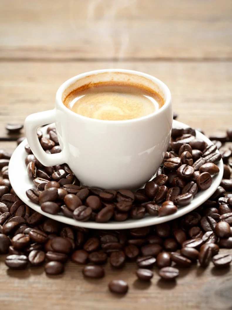 Small coffee cup with hot esspresso on old table. This file is cleaned and retouched.
