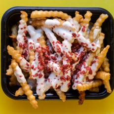 Waffle fries topped with ranch dressing and bacon bits from Eegees in Arizona. One of our iconic Arizona dishes and the restaurants that serve them. Food photography and article by Jackie Alpers for the Food Network.