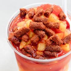 Mangonada respado from Sonoran Delights made with chamoy sauce, mangos, lime juice and chili powder and is decorated with tamarind candy. One of our iconic Arizona dishes and the restaurants that serve them. Food photography and article by Jackie Alpers for the Food Network.